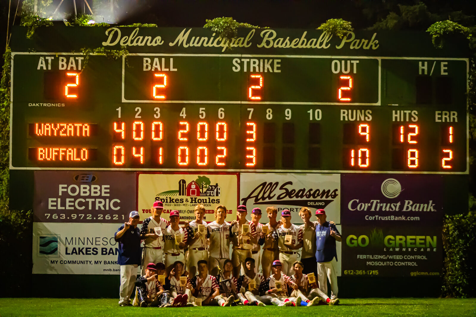 Buffalo celebrates the 2026 Stars and Stripes championship beneath the Delano Municipal Baseball Park scoreboard